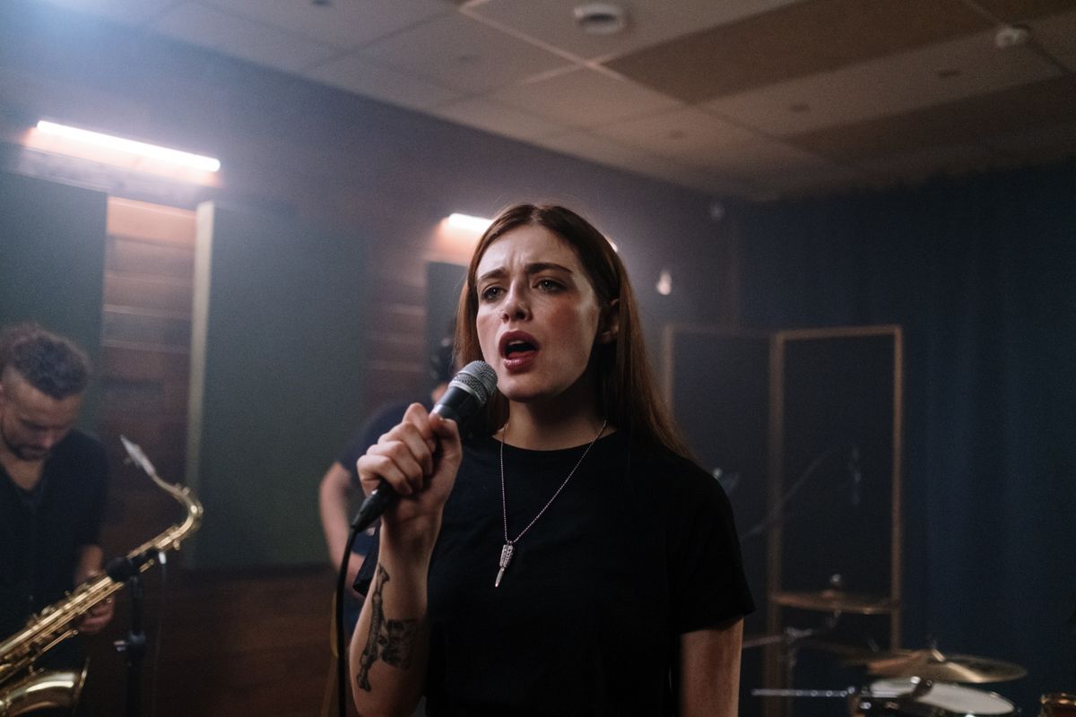Guess the song game with a singer performing with a band