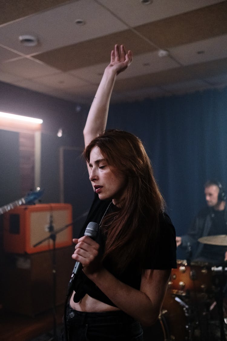 Woman In Black Shirt Holding Microphone