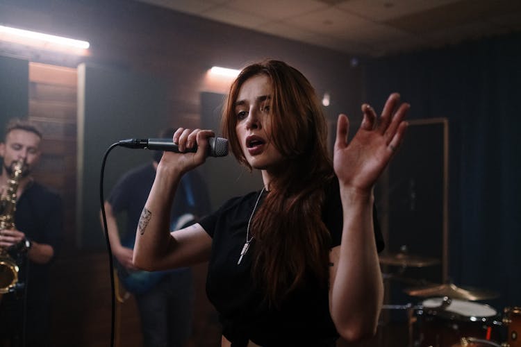 Woman In Black Tank Top Singing