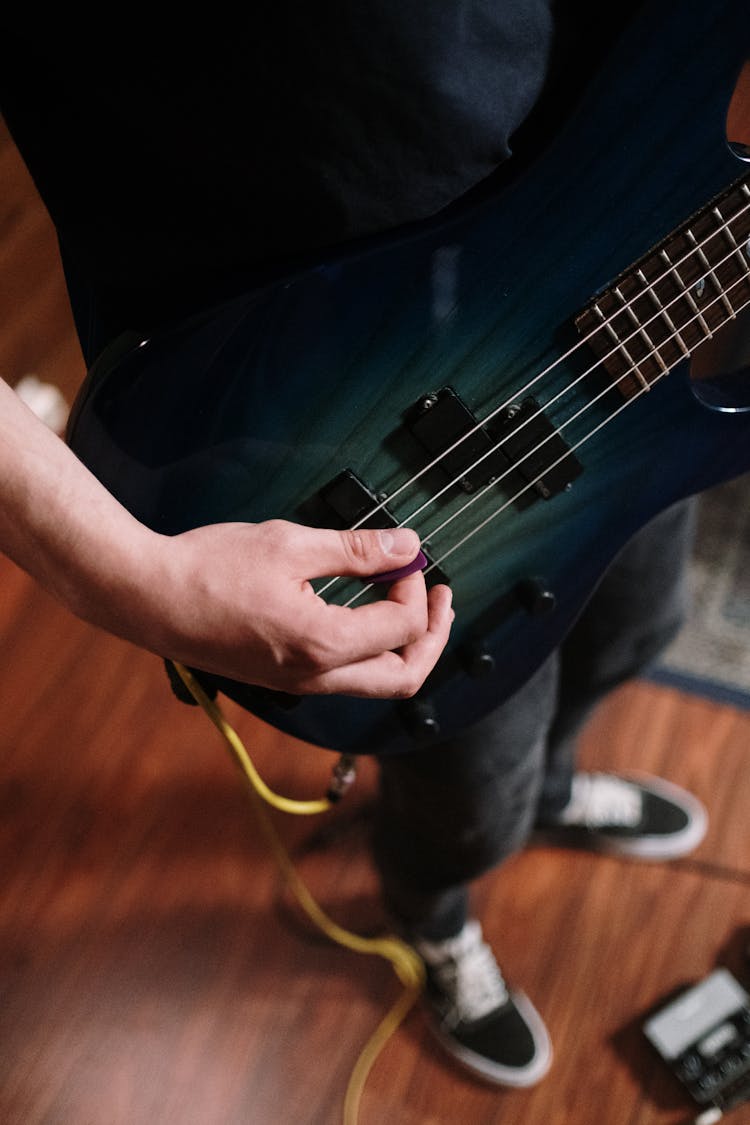 Person Playing Black Electric Guitar