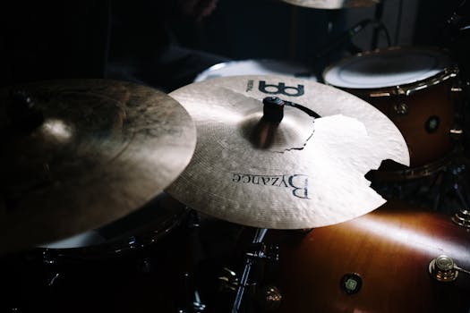 A close-up of a cracked cymbal in a drum set with selective focus.