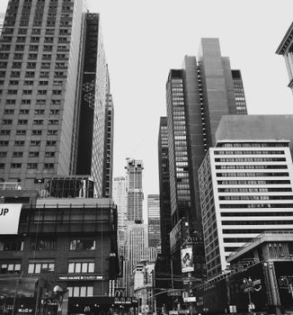 Stunning black and white view of towering skyscrapers in New York City, capturing urban life.