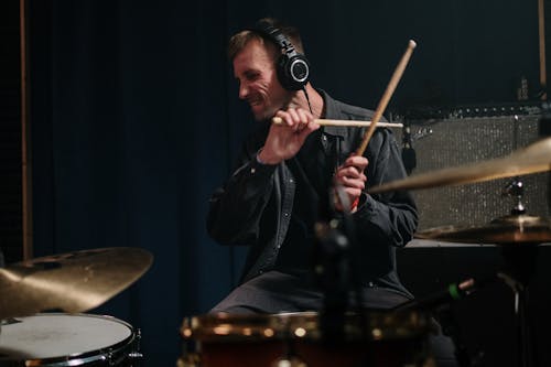 Free Man Playing Drums Passionately Stock Photo