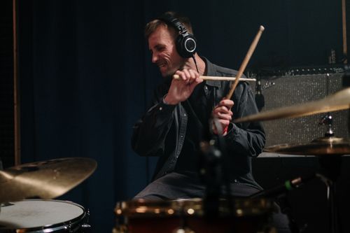 Free A passionate drummer energetically playing drums in a music studio. Stock Photo