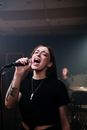 Woman in Black Crew Neck T-shirt Singing