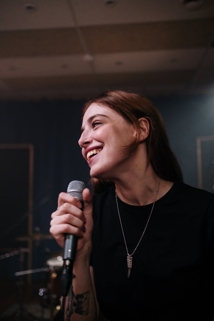 A Woman Smiling While Singing