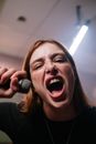 Woman in Gray Shirt Holding Microphone