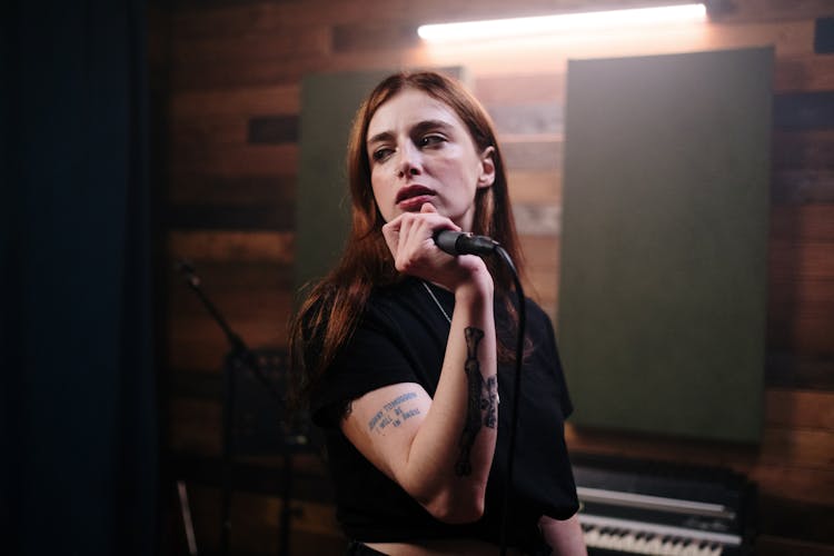 Woman In Black T-shirt Holding Microphone