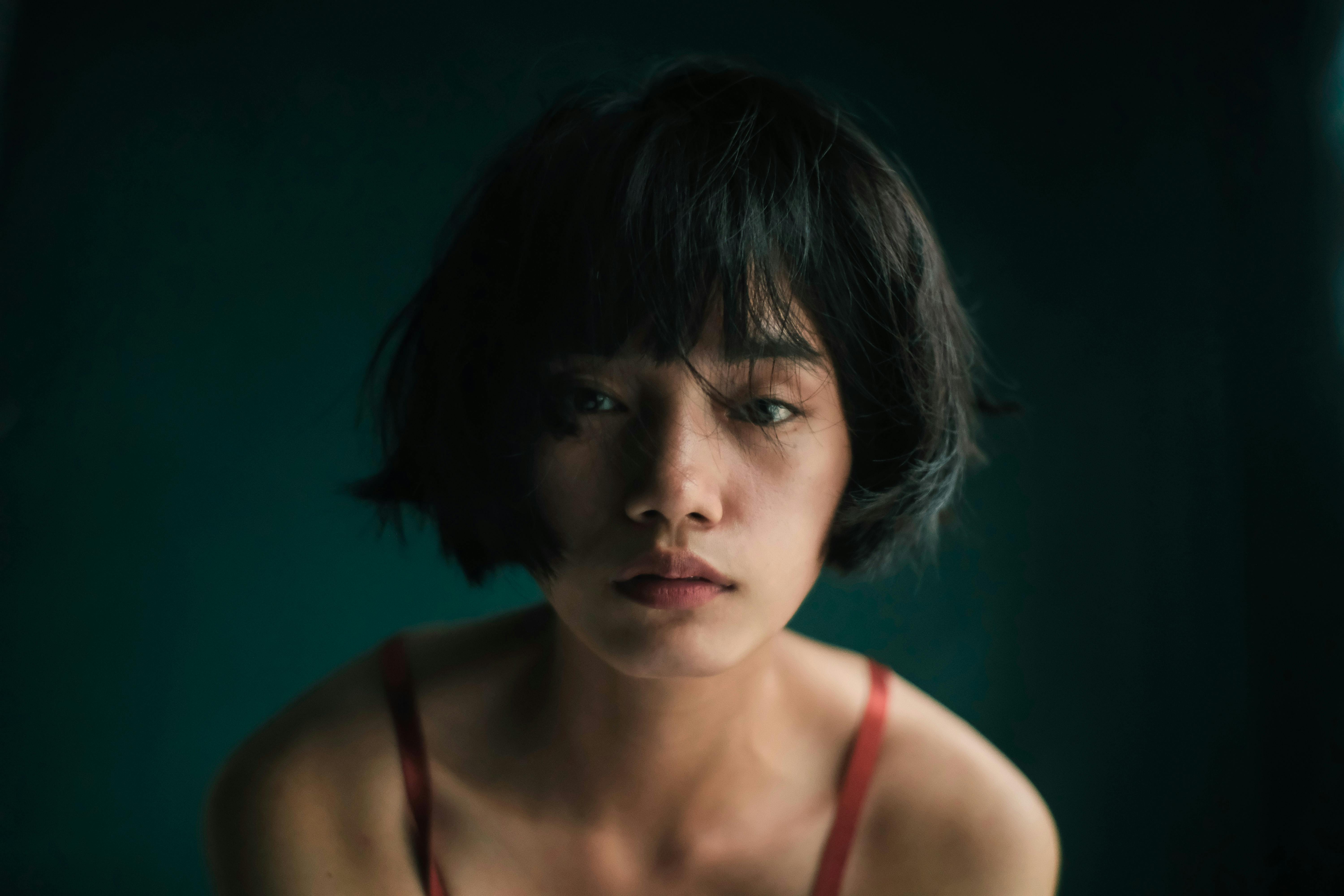 Tired Asian female with disheveled hair · Free Stock Photo