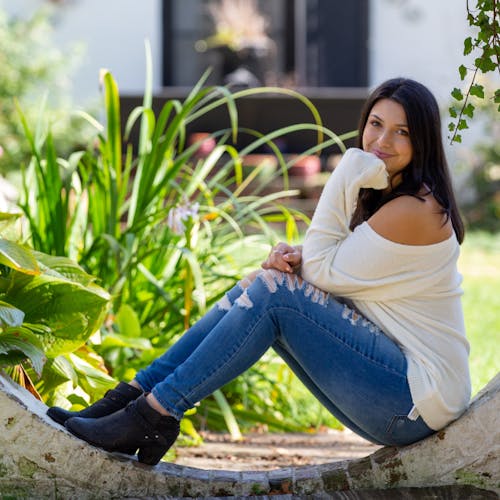 Positive woman sitting on concrete construction