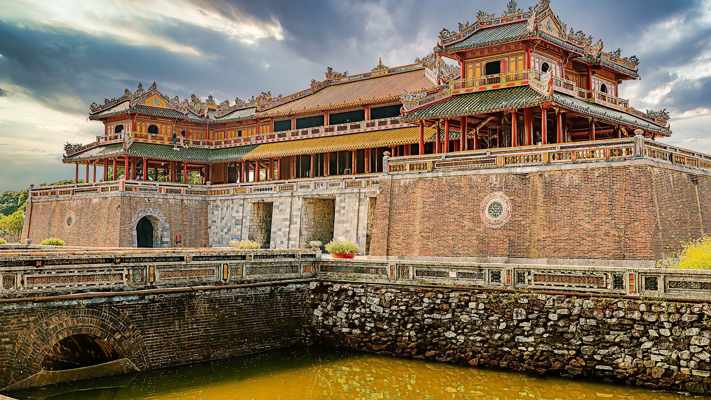 Beautiful Vietnamese temple with rich architecture against a dramatic sky, showcasing heritage.