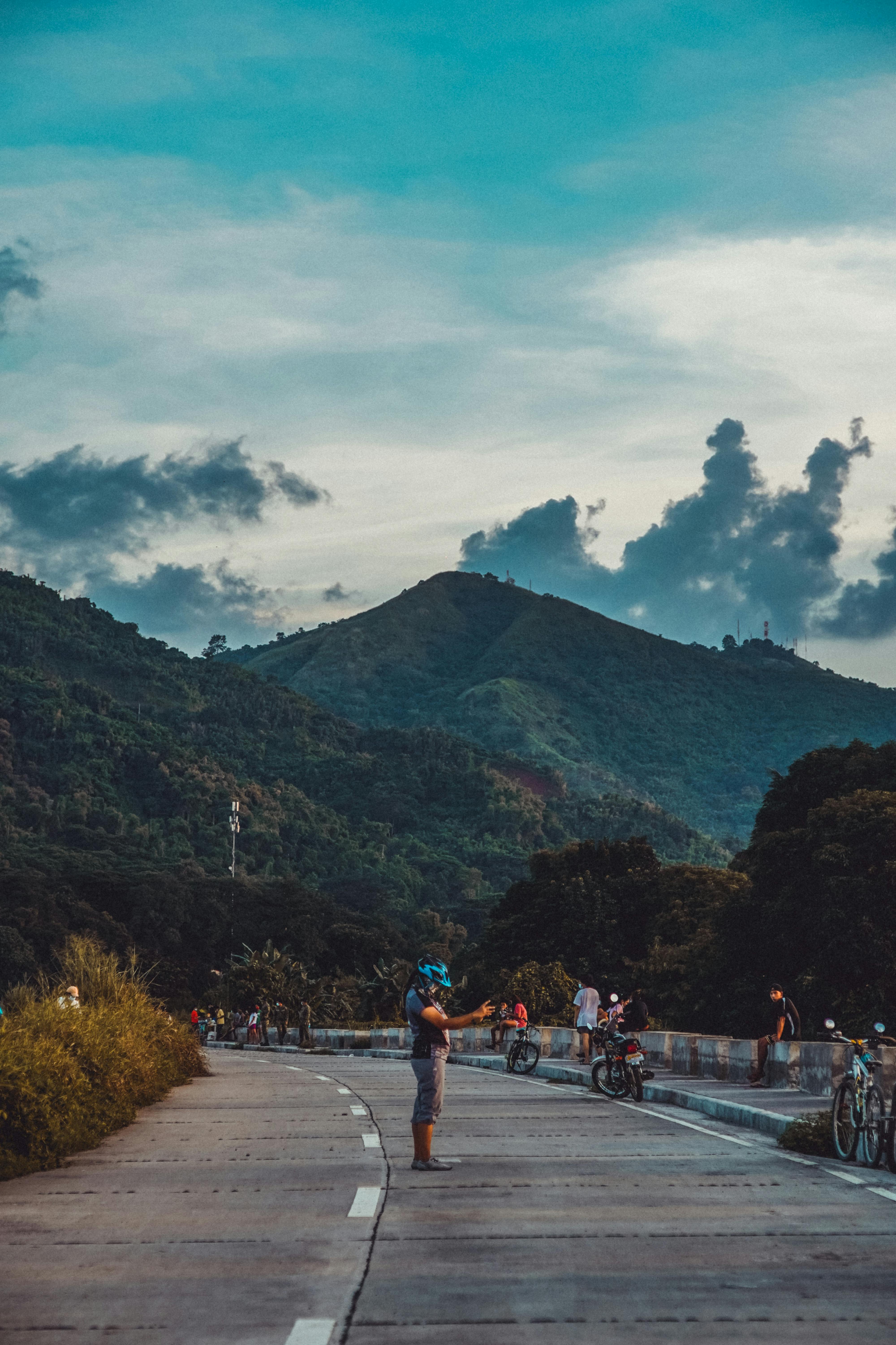 A cyclist pauses to admire the beautiful mountain landscape in Rodriguez, Philippines.