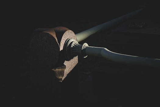 A detailed close-up of a stone railing showcasing texture and shadow in dim light.