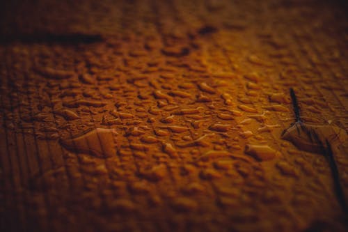 Textured background of pure water drops on ribbed surface