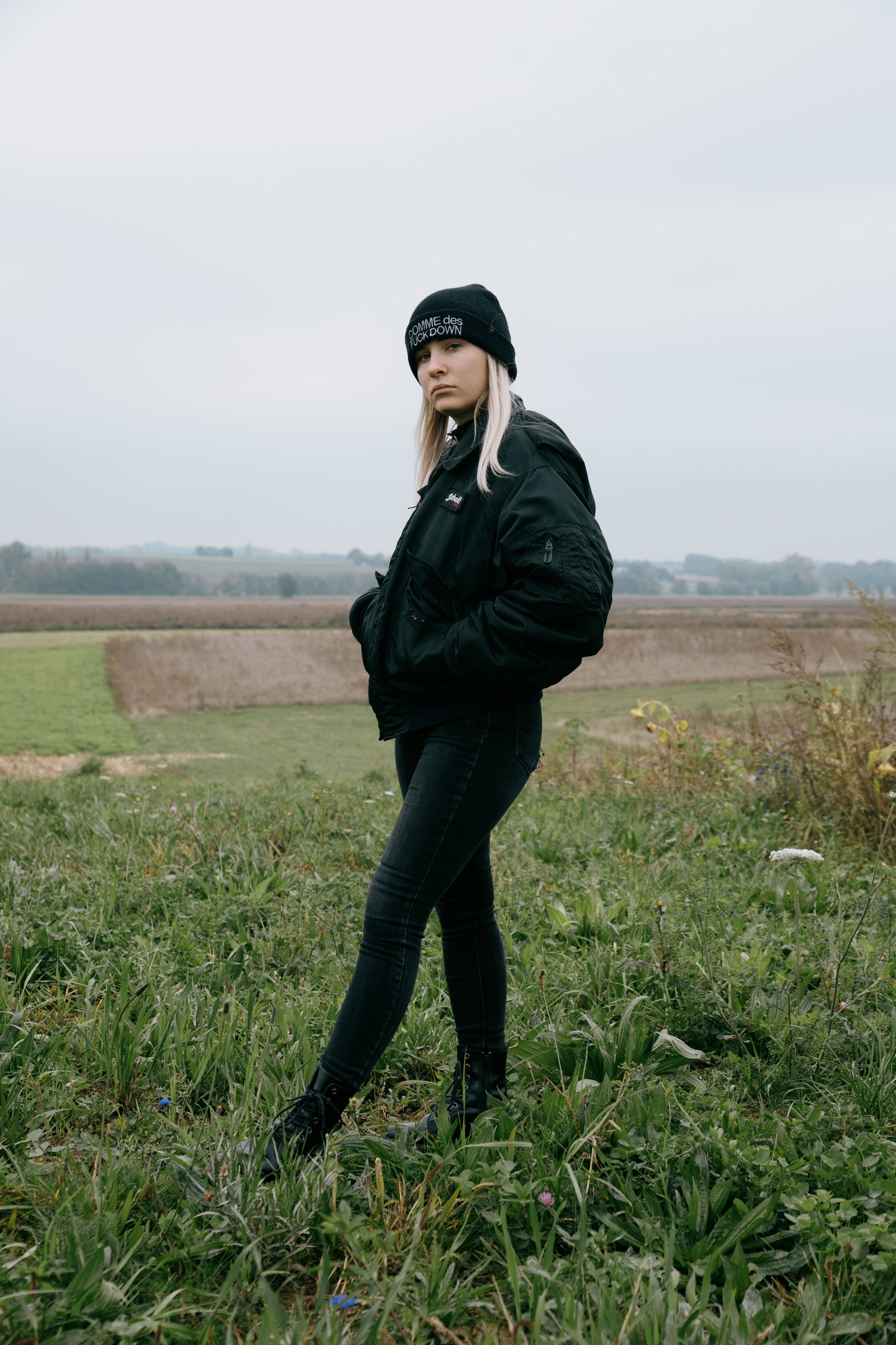 Woman in Black Jacket Standing on the Grass · Free Stock Photo