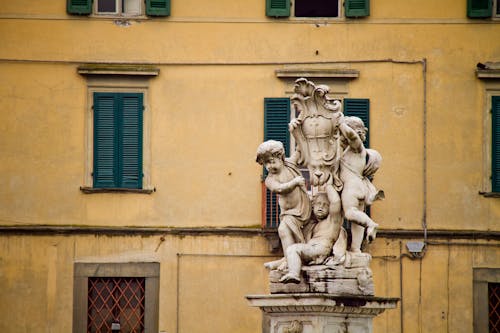 Ancient Sculpture against City Building