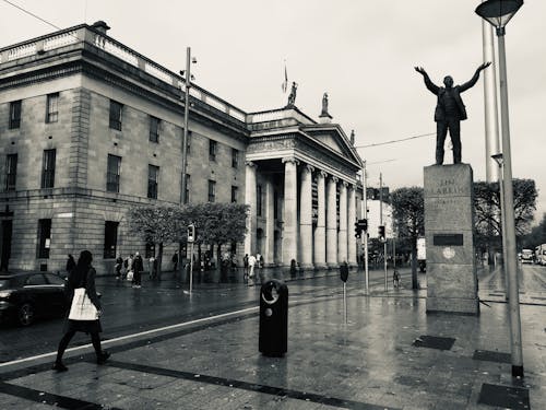 Grayscale Photo of People Walking on Street Near GPO Museum