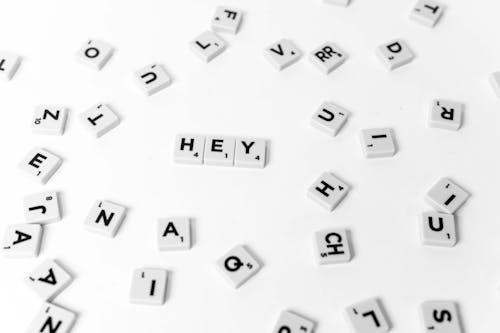 White and Black Scrabble Tiles on a White Surface