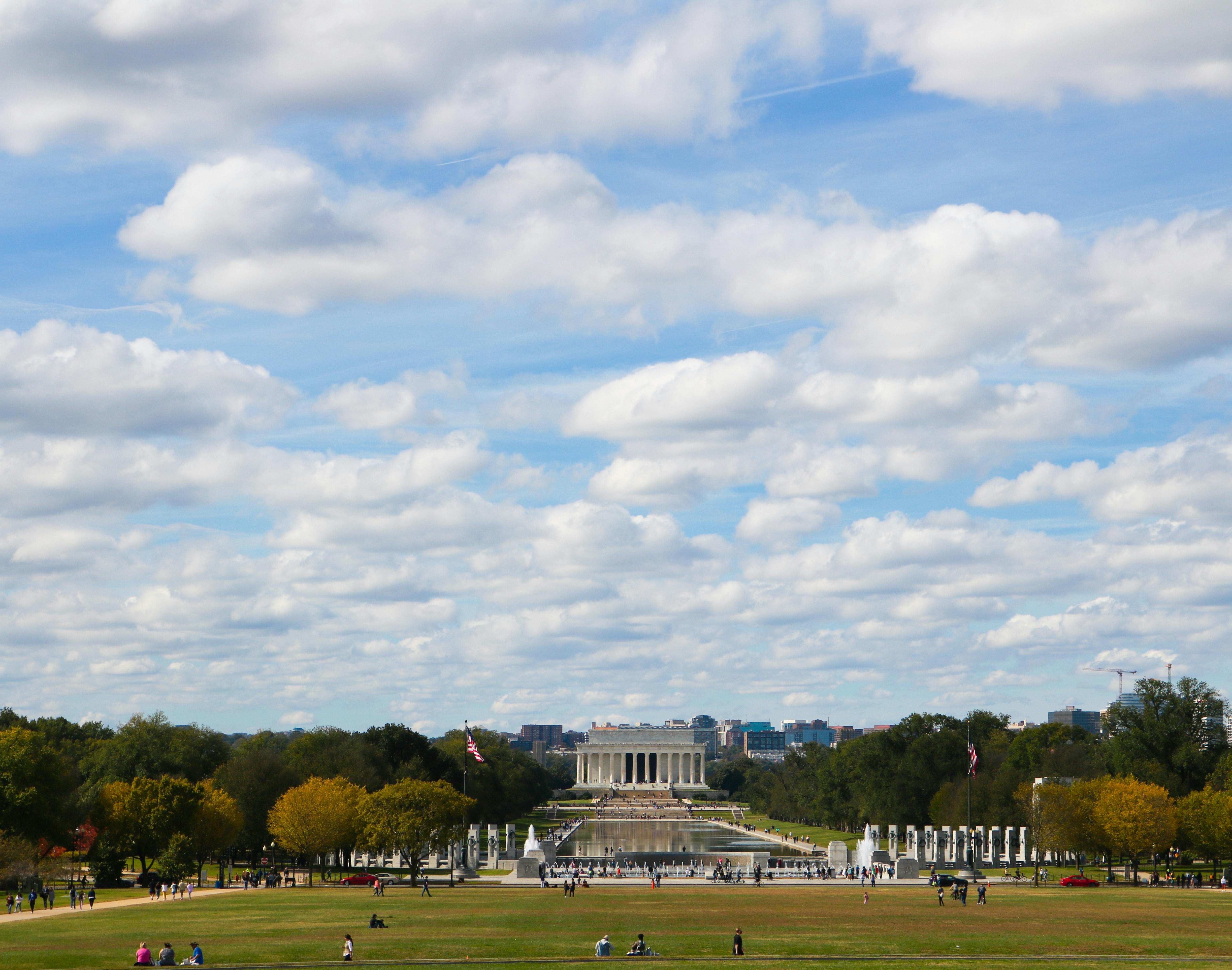Scenic view of the iconic Lincoln Memorial under a vibrant sky, surrounded by lush greenery.