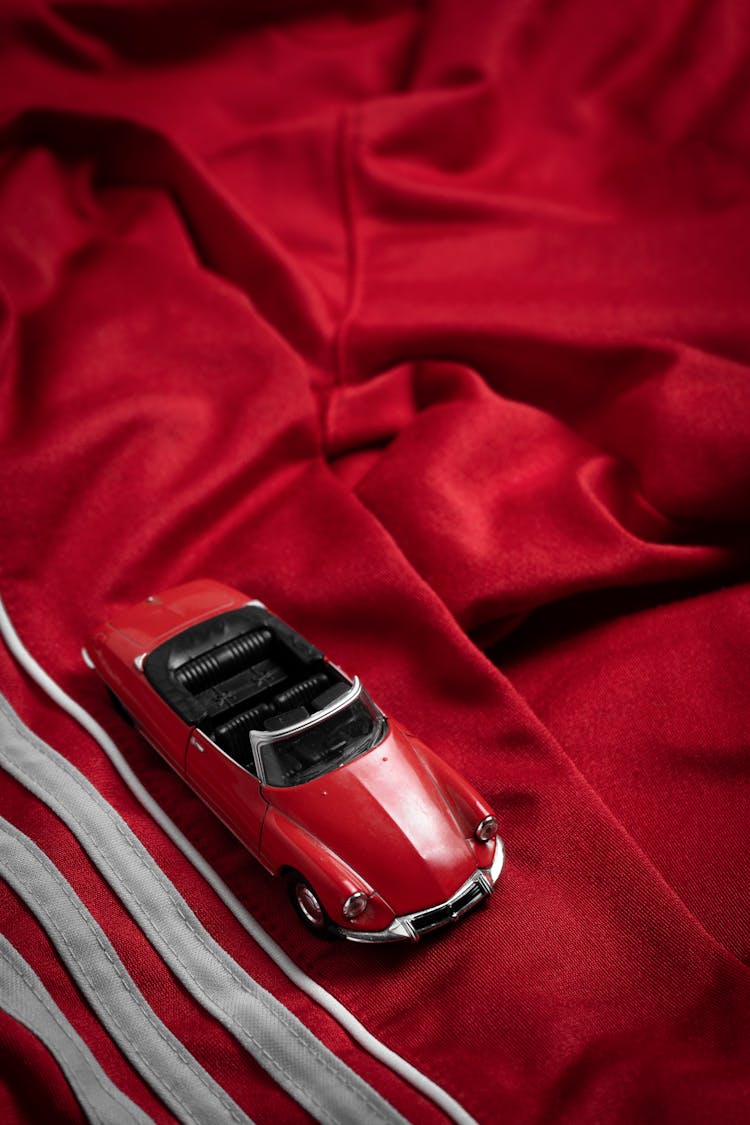 Red Toy Car On Fabric