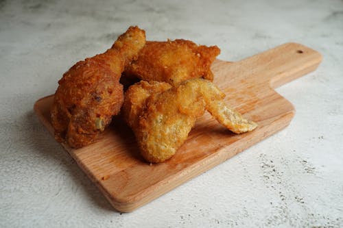 Fried Chicken on a Wooden Cutting Board