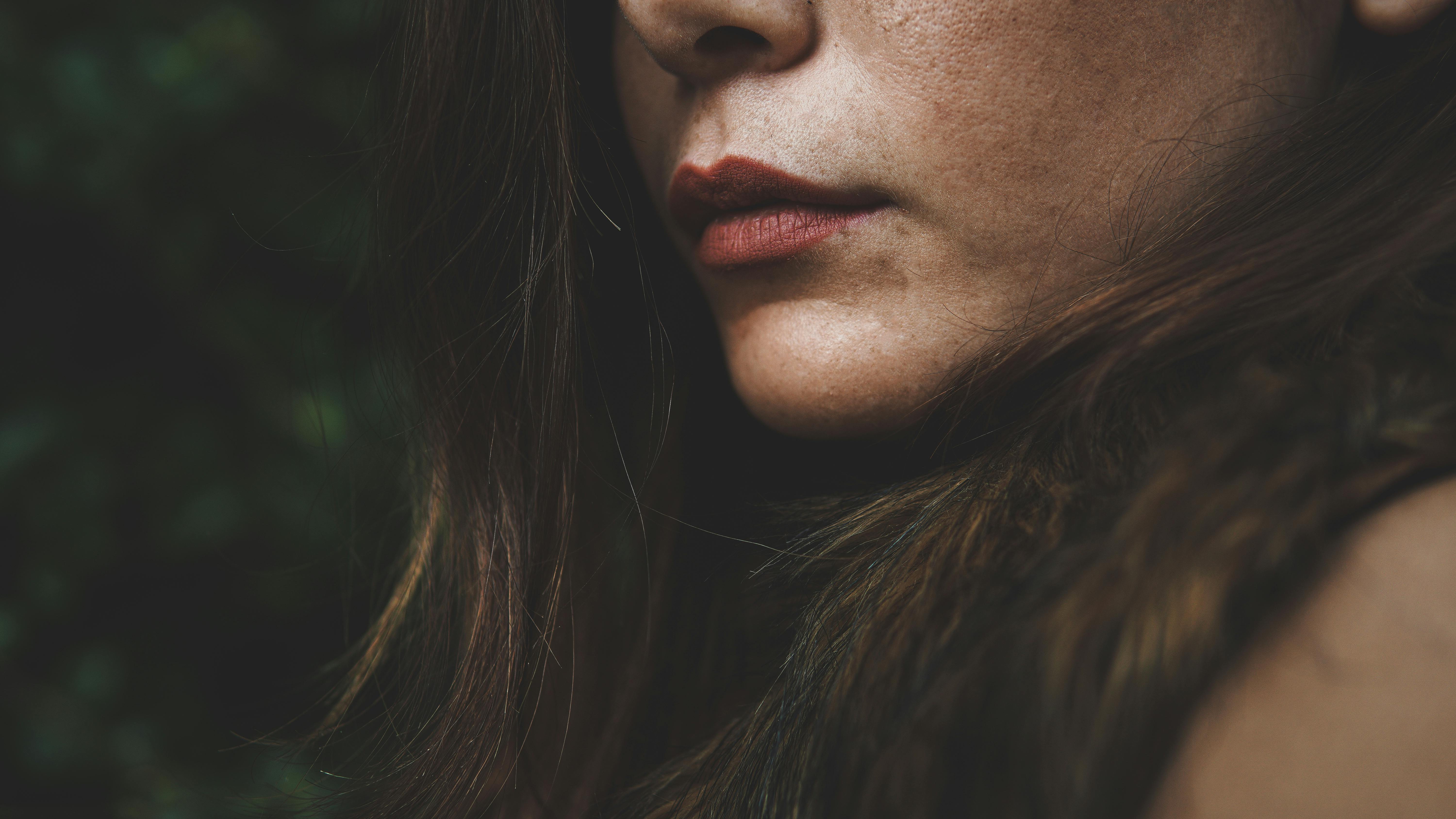 Detailed close-up of a woman's face highlighting her lips, showcasing beauty and texture.