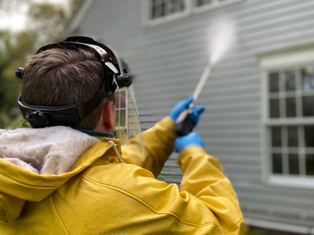 Pressure washer removing grime from a paved surface