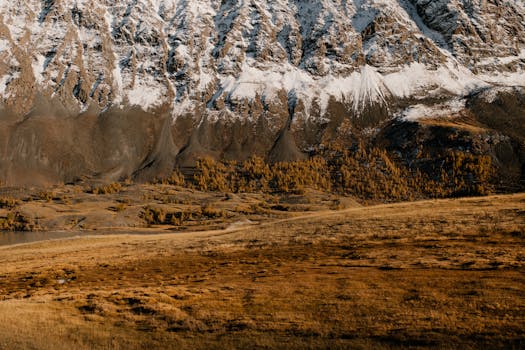 Breathtaking mountain landscape with autumn foliage and snow-capped peaks.