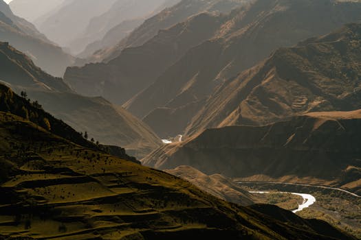 Captivating aerial shot of a vast mountain range at sunset, showcasing nature's grandeur.