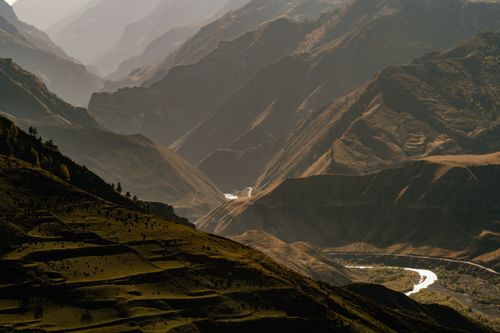 Free Captivating aerial shot of a vast mountain range at sunset, showcasing nature's grandeur. Stock Photo