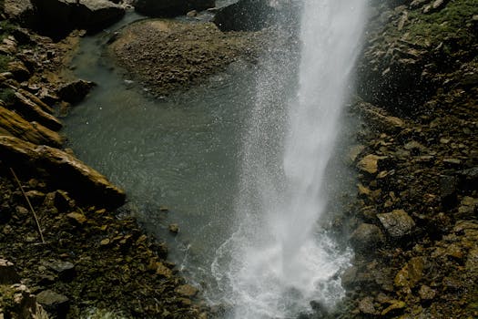 High angle view of a stunning waterfall cascading over mossy rocks in a natural setting.