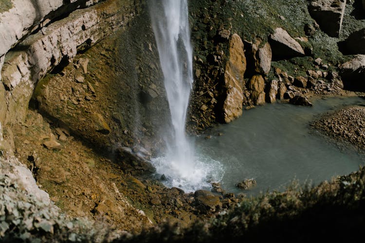 Water Falls On Brown Rocky Mountain