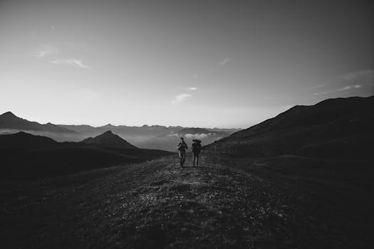 Two hikers enjoy a scenic adventure in the hills of Cesana Torinese, Piemonte.