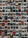 Instant shots with different bright memories of travelling and journeys hanging on wall