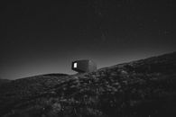 Grayscale Photo of House on Hill