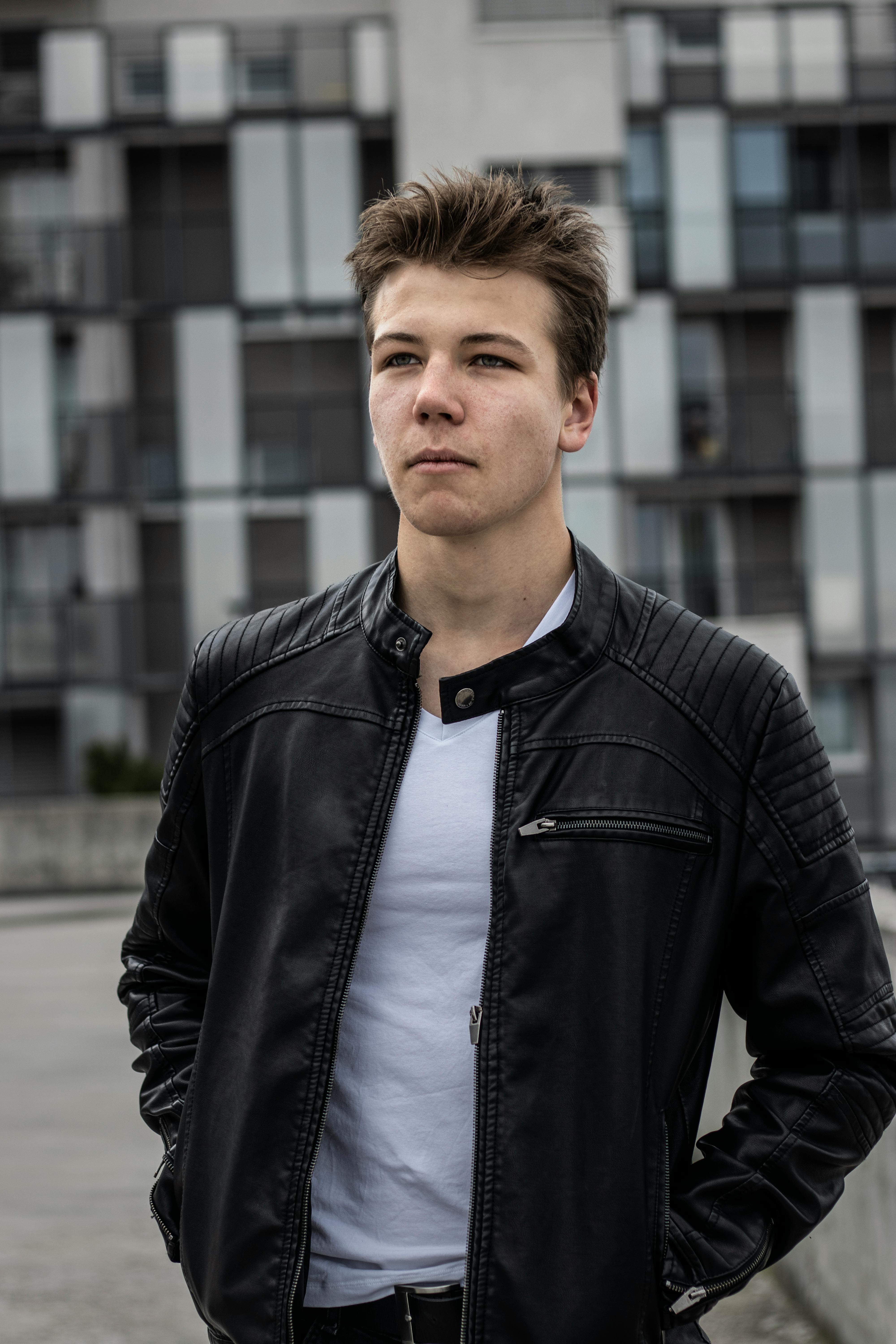 Man in Black Leather Jacket Standing on Road · Free Stock Photo