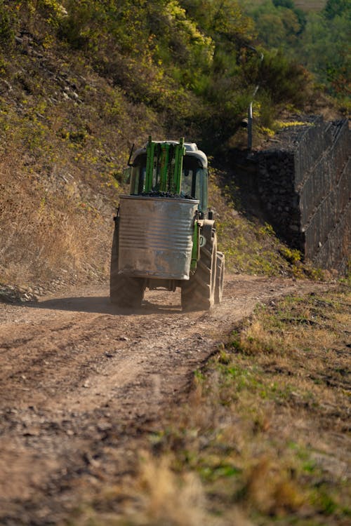 Tractor driving along dusty rural road