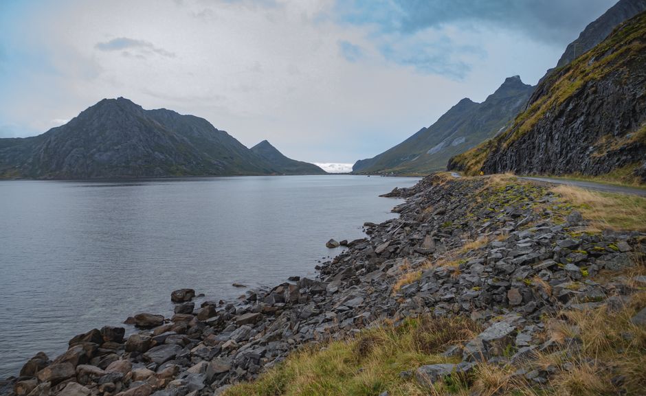A tent set up for wild camping with a stunning fjord view in rural Norway, illustrating Allemannsretten.