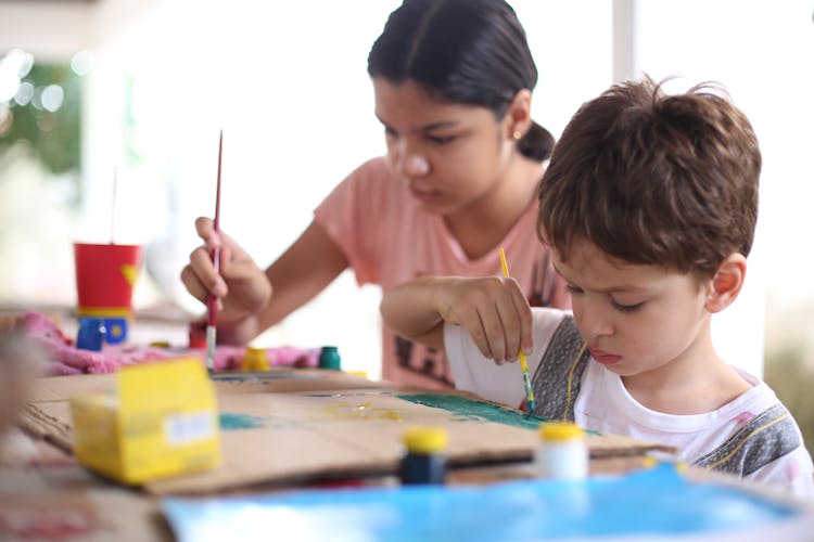 A Girl And Boy Doing Painting 