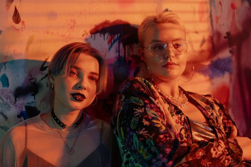 Free A colorful indoor portrait of stylish young women with unique fashion and bold makeup. Stock Photo