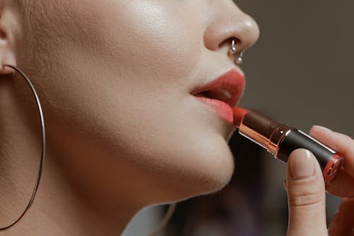 Woman Putting on a Lipstick