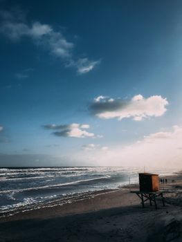 Serene Montevideo beach at sunrise with lifeguard tower and soft waves, capturing a tranquil morning.