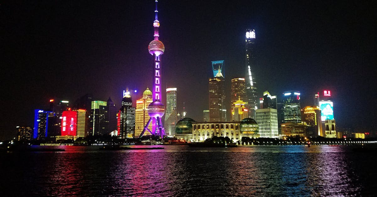 Vibrant night view of Shanghai's illuminated skyline featuring the iconic Oriental Pearl Tower.