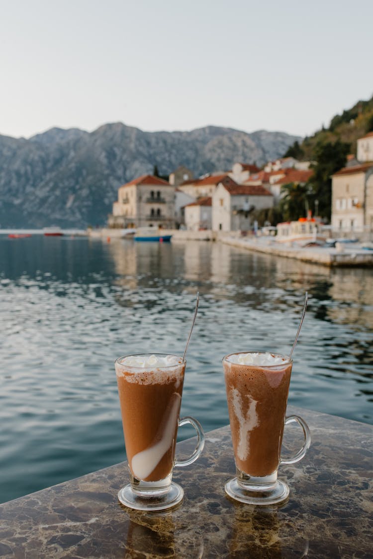 Coffee In Glasses On Lake Background