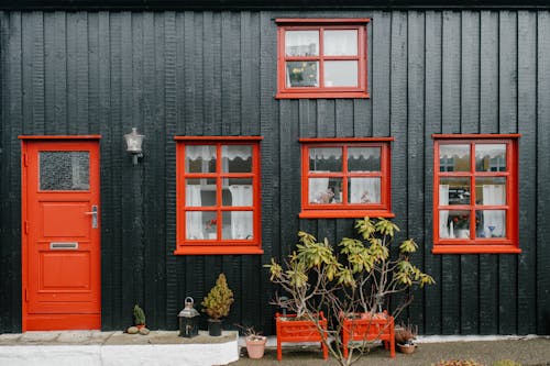Red Wooden Framed Glass Windows on a Wooden House