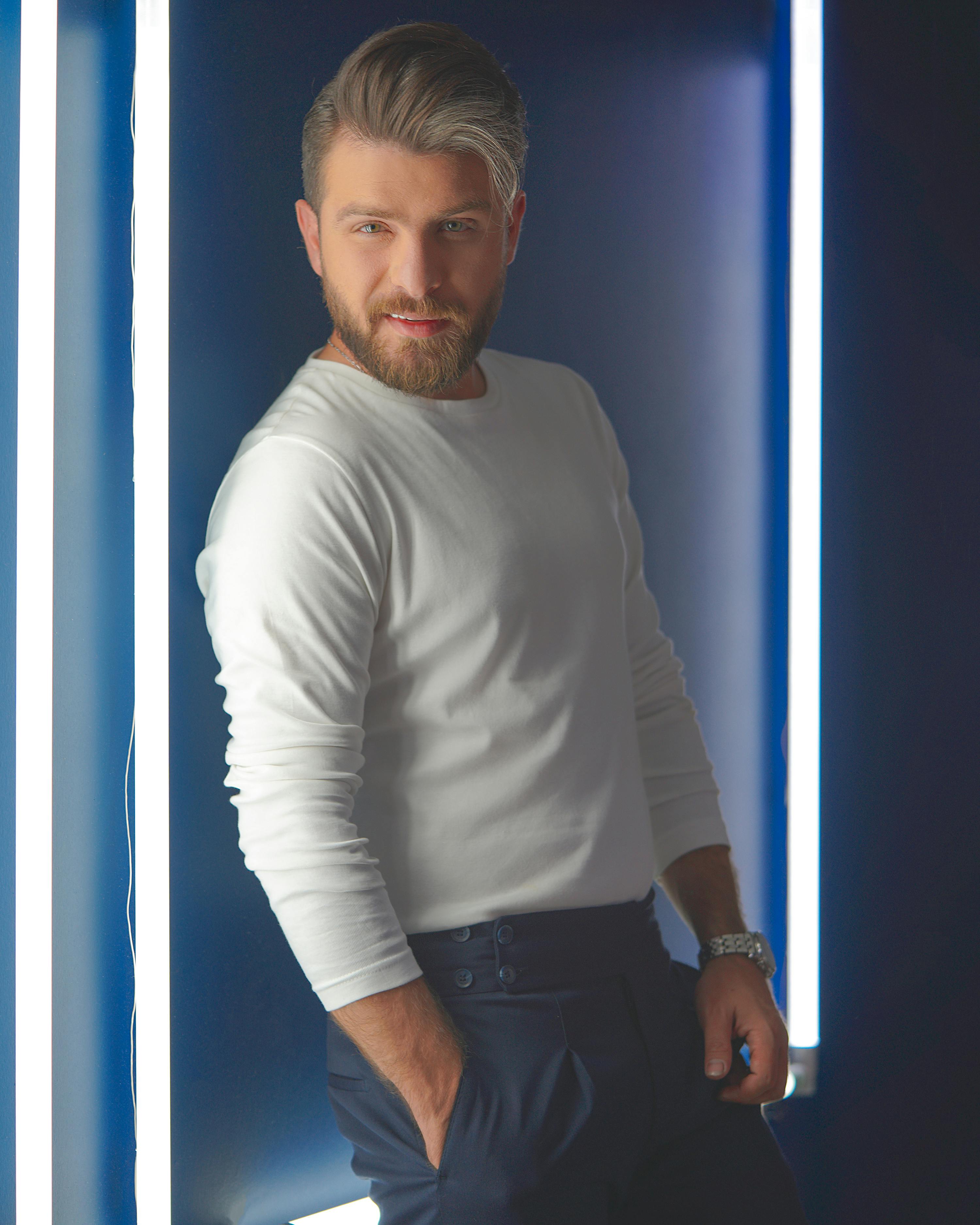 Elegant portrait of a bearded man in Tehran, capturing fashion and style.