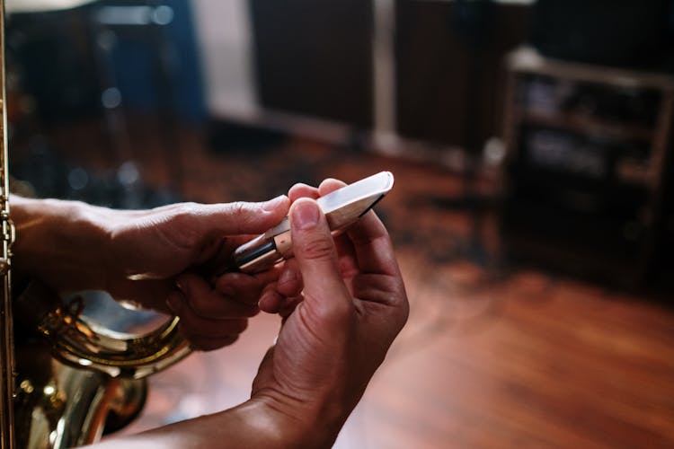 A Person's Hand Holding Saxophone Mouthpiece