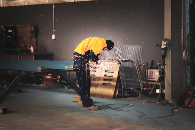 A Man Grinding The Metal