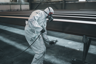 Man in White Suit and Helmet Standing on Gray Concrete Floor