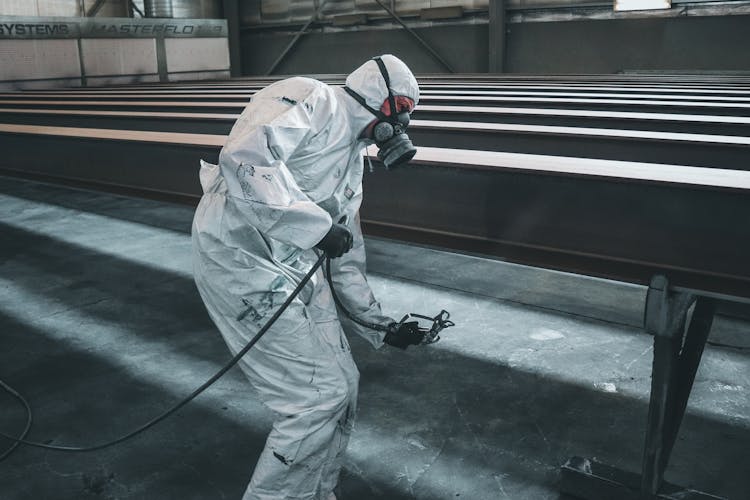 A Person Painting The Metal